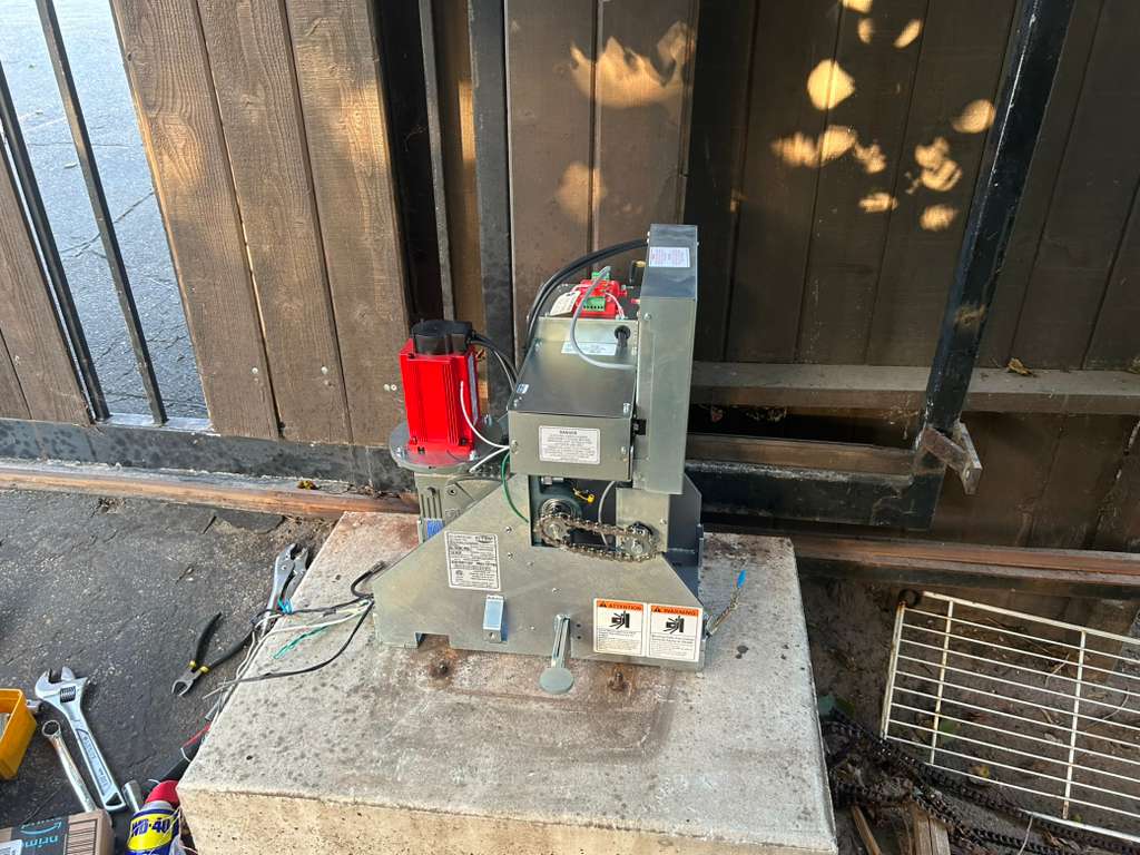 Gate motor and opener unit by wooden gate with tools