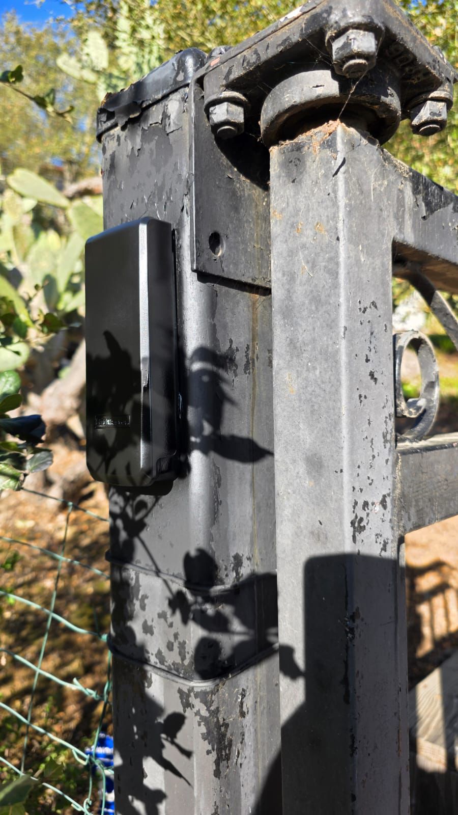 Black gate access control unit on weathered gate post in Mar Vista, CA